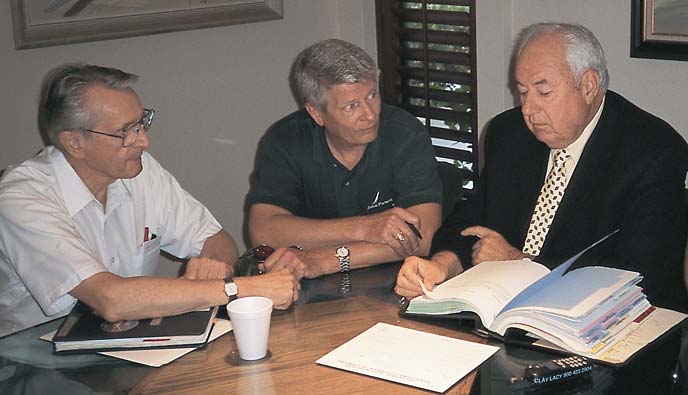 (L–R) AVIATION PARTNERS DIR FLIGHT TEST DICK SEARS, CHIEF PILOT RICK MILLSON AND PILOT AUTHOR CLAY LACY DISCUSS PERFORMANCE SPECIFICATIONS OF THE HAWKER 800 EQUIPPED WITH AVIATION PARTNERS BLENDED WINGLET TECHNOLOGY.